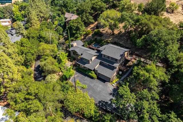 an aerial view of a house with a yard
