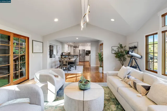 a living room with furniture and painting on the wall
