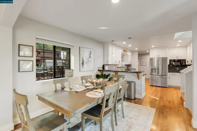 a kitchen with granite countertop white cabinets and stainless steel appliances