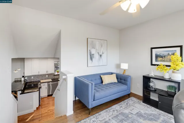 a living room with furniture flat screen tv and a large window