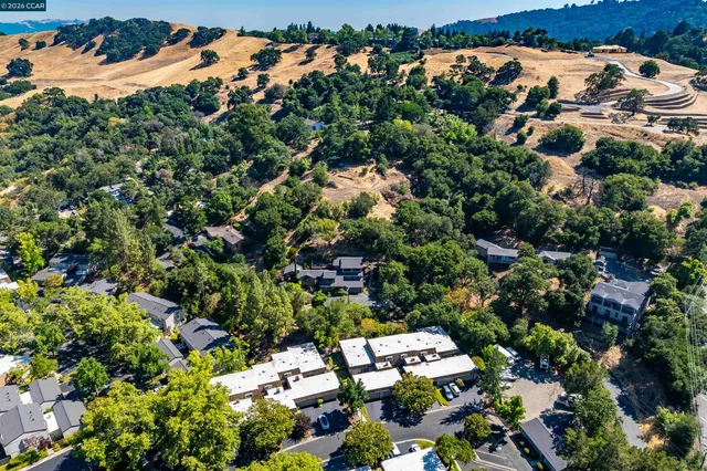 an aerial view of a house with a yard