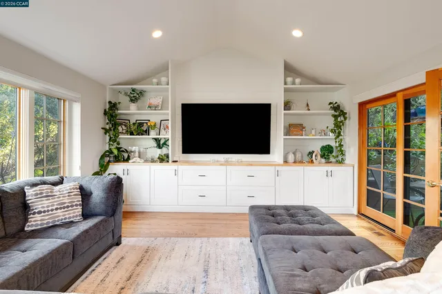 a living room with furniture a large window and a fireplace