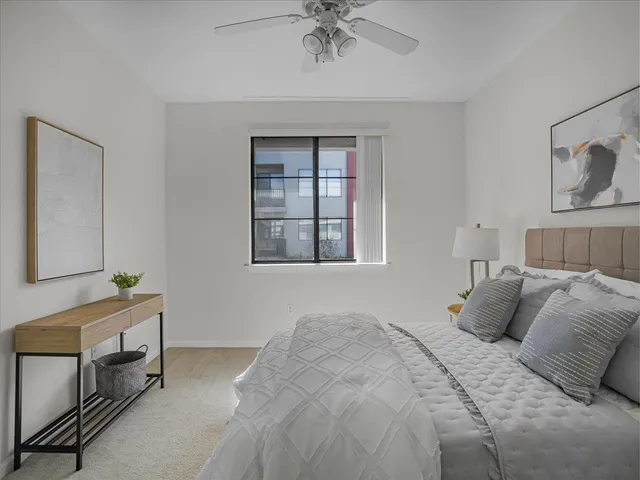 a bedroom with a bed and a window