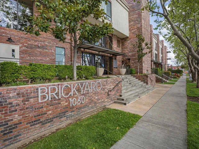 a view of a brick house with a large windows