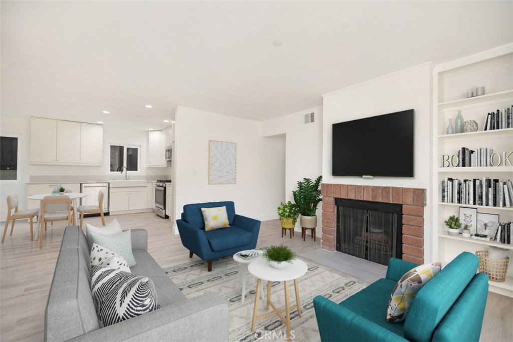 a living room with furniture a flat screen tv and a fireplace