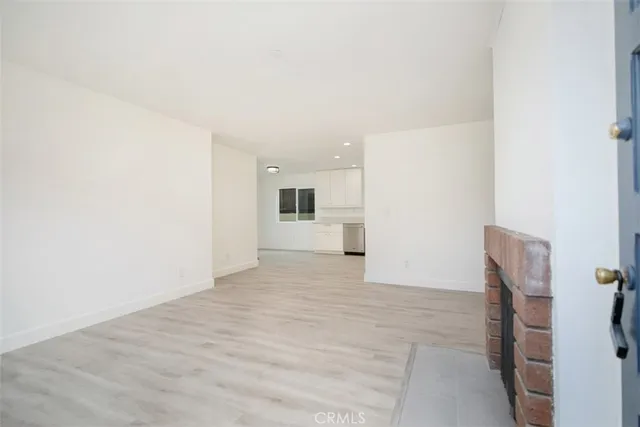 a view of a kitchen with a sink and a refrigerator