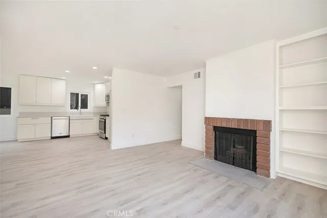 a view of a kitchen with a sink and a fireplace