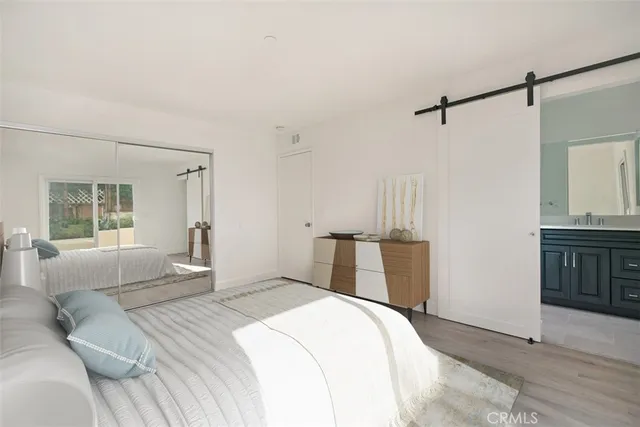 a bedroom with a large bed and a dresser