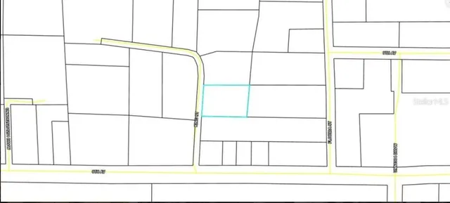 an aerial view of residential houses with outdoor space and trees