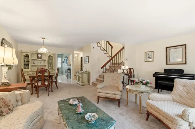 a living room with furniture and a dining table with wooden floor
