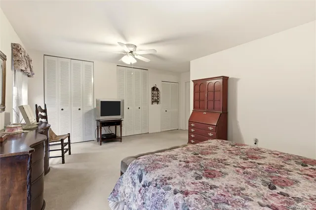 a bedroom with a bed and dresser