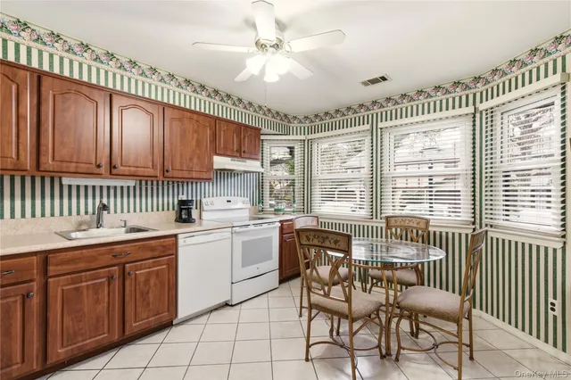 a kitchen with a dining table chairs and large window