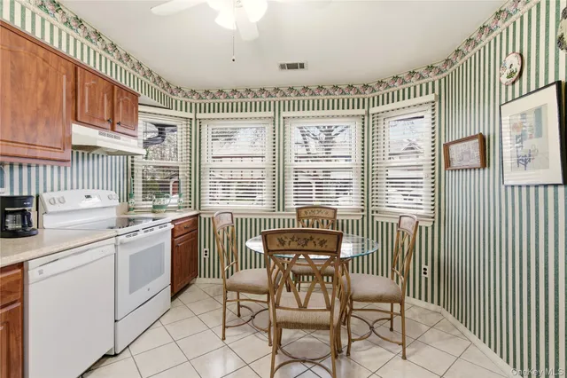 a view of a dining room with furniture and windows