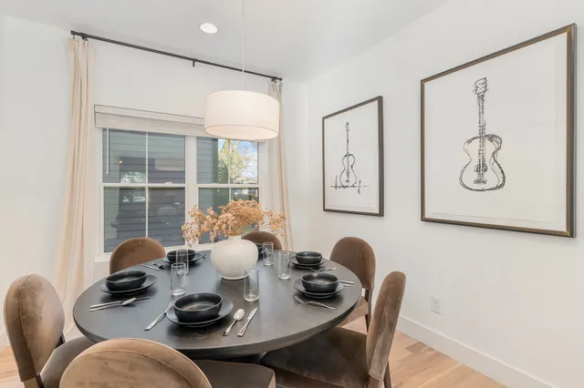 a dining room with furniture and window