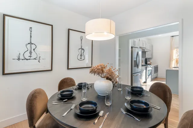 a dining room with furniture and wooden floor