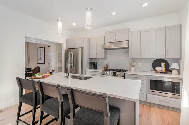 a kitchen with a stove a sink and a refrigerator