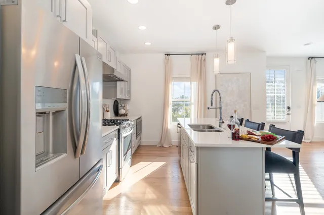 a large kitchen with lots of counter space and stainless steel appliances
