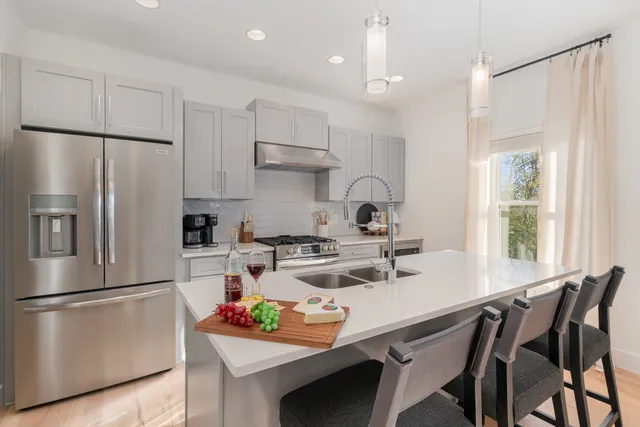 a kitchen with a refrigerator a stove a sink and a refrigerator