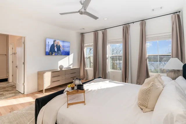 a bedroom with a large bed and a large window