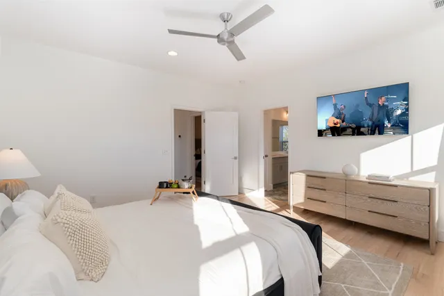a bedroom with a bed and a flat screen tv