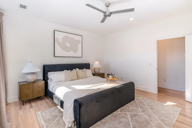 a bedroom with a bed and a painting on the wall