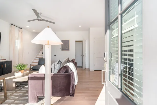 a living room with furniture and a chandelier