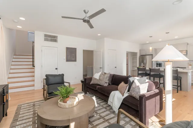a living room with furniture and a chandelier