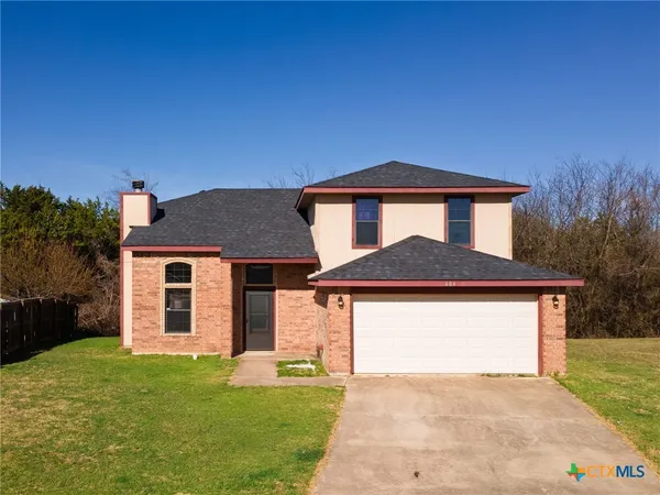 a front view of a house with yard