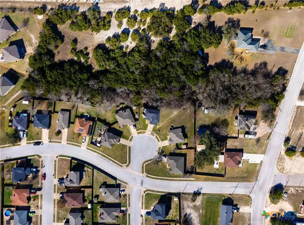 an aerial view of a house with yard swimming pool and mountain view