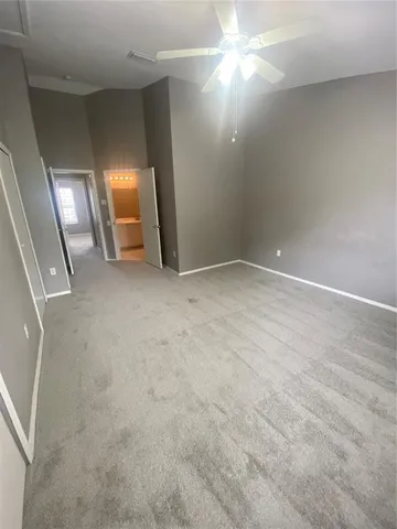 an empty room with stairs and wooden floor