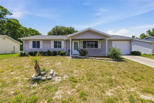 a front view of house with yard and green space