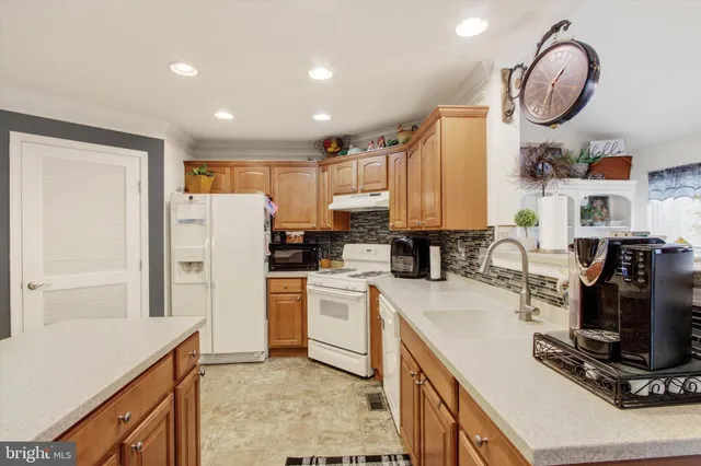 a kitchen with a refrigerator and a sink