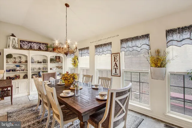 a view of a dining room with furniture and chandelier