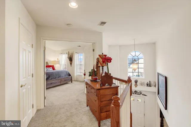 a living room with furniture and a mirror