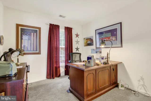 a utility room with dryer washer and a view of living room