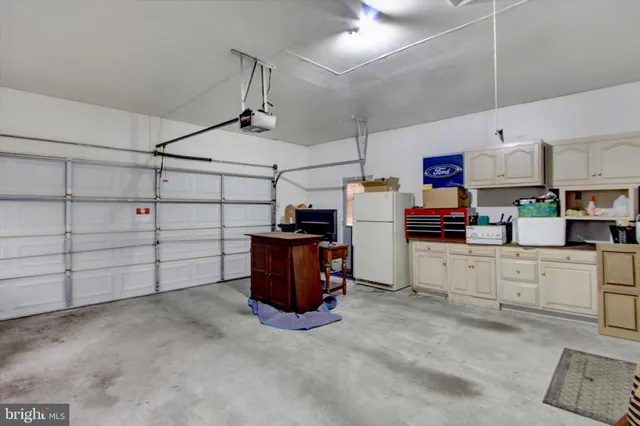 a view of a house with wooden deck and furniture
