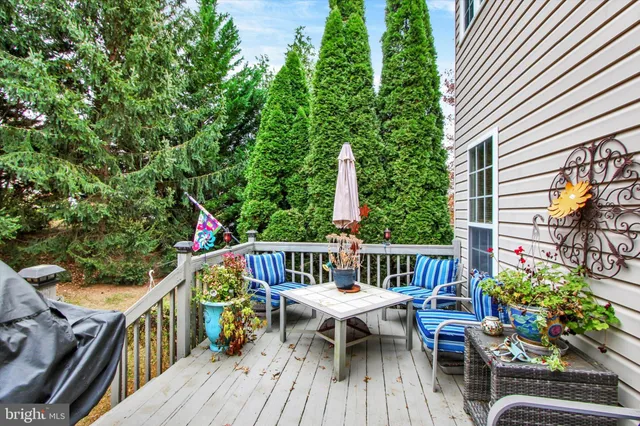 a view of house that has a small yard and large trees