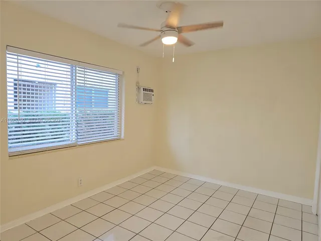 a view of kitchen with refrigerator and cabinets