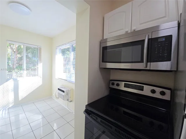 a kitchen with a stove and a microwave