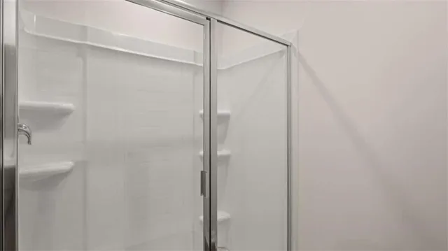 a bathroom with a glass shower door