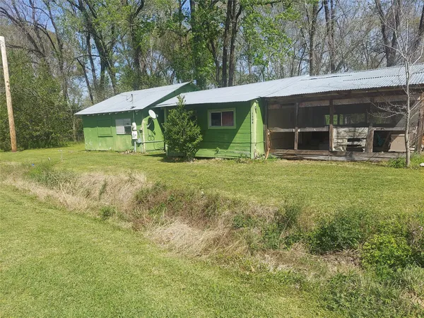 a view of a house with a yard and sitting area