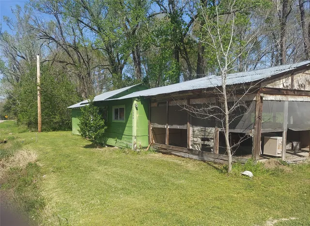 a view of a backyard with table and chairs