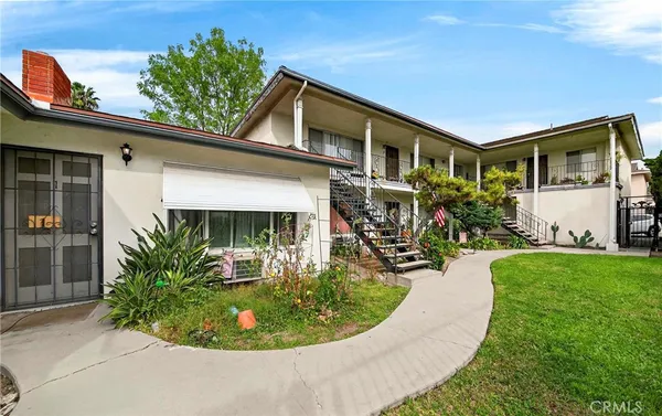 a view of a house with roof walls and potted plants