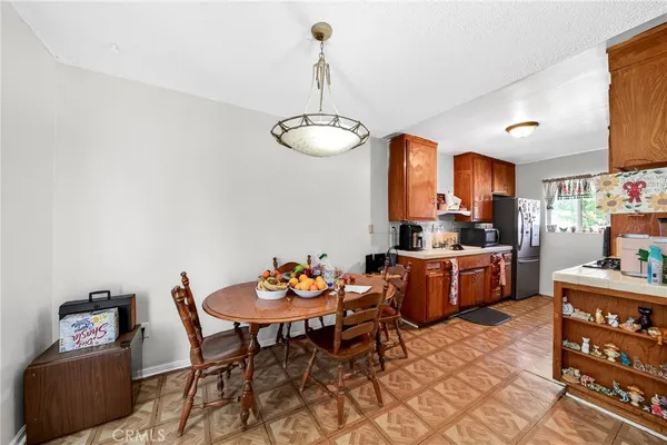 a kitchen with stainless steel appliances kitchen island granite countertop a sink and a refrigerator