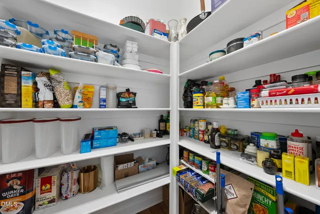 a kitchen with a sink and wooden floor