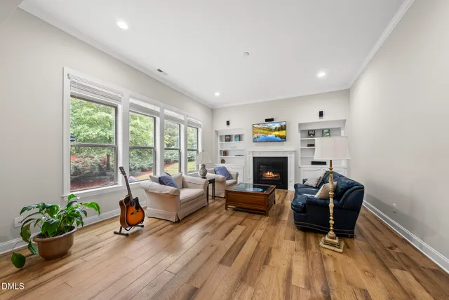 a dining room with furniture a chandelier and wooden floor