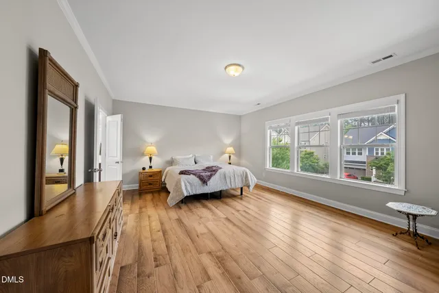 a bed room with a bed window and a dresser