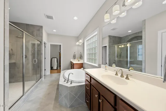 a spacious bedroom with a bed and wooden floor