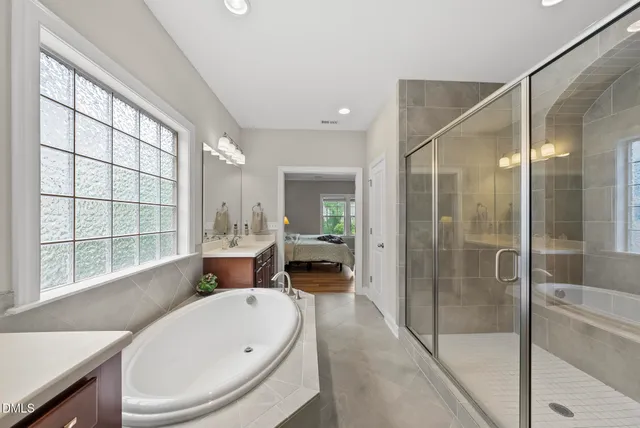 a spacious bathroom with a sink mirror and shower