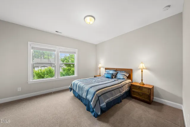 a bathroom with a white tub shower and mirror